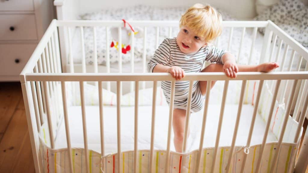 Toddler climbing out of cot