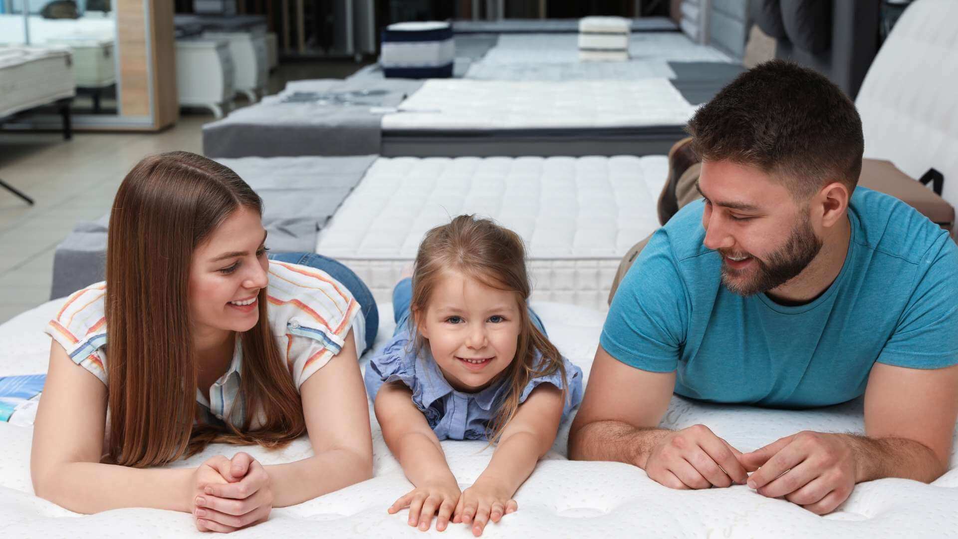 Family trying a mattress in-store