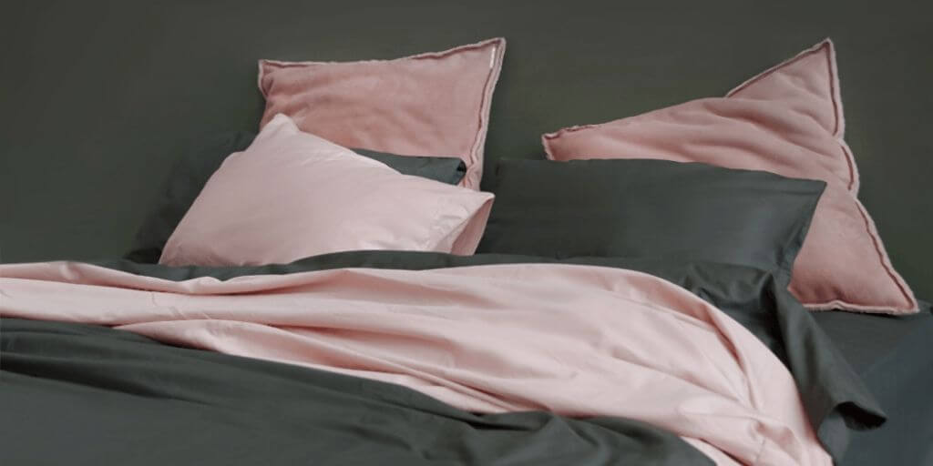 Black and pink coloured pillows and bedding