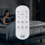 Remote for Sealy adjustable bed base with adjustable bed in background