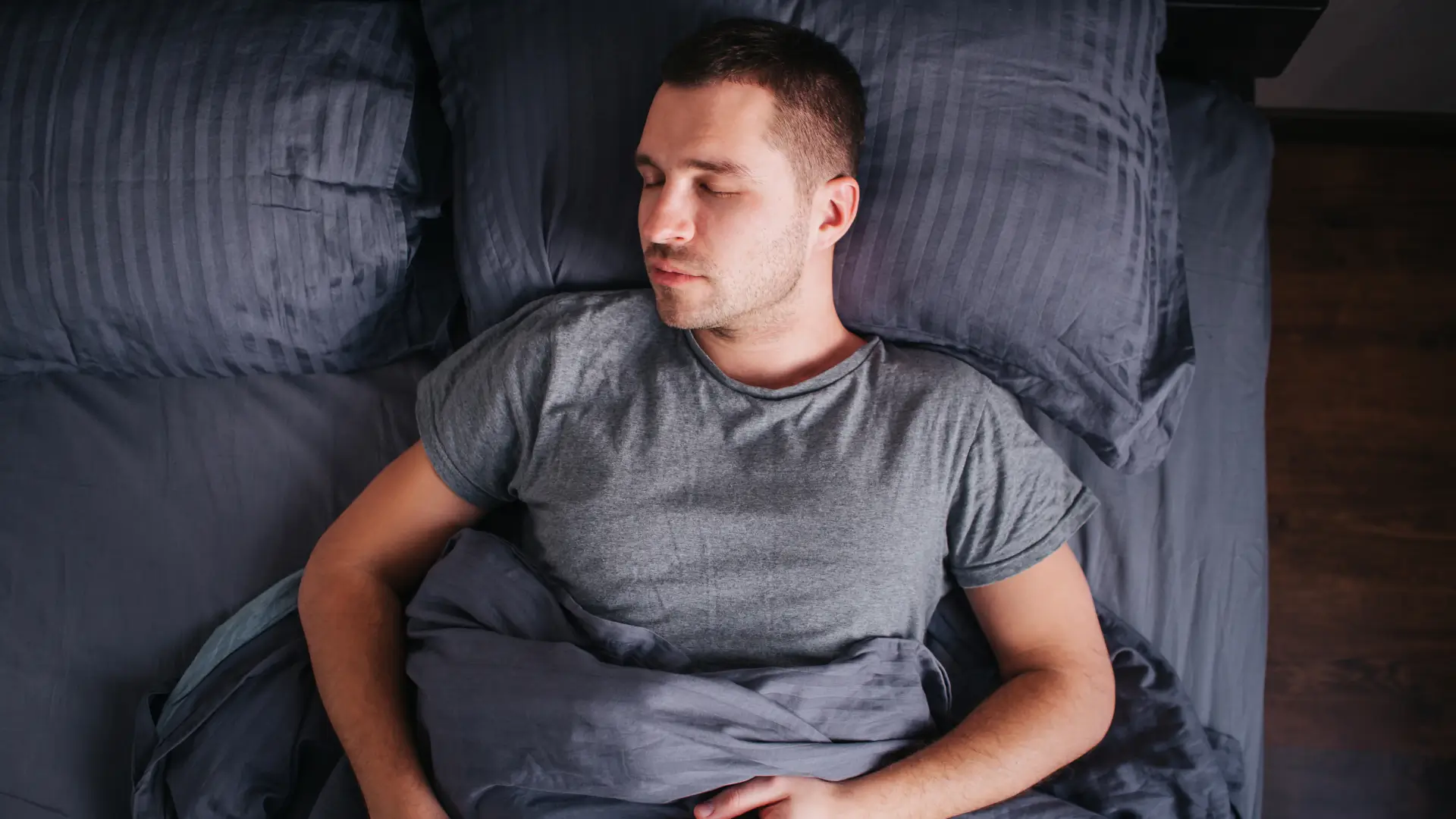 Man asleep in bed
