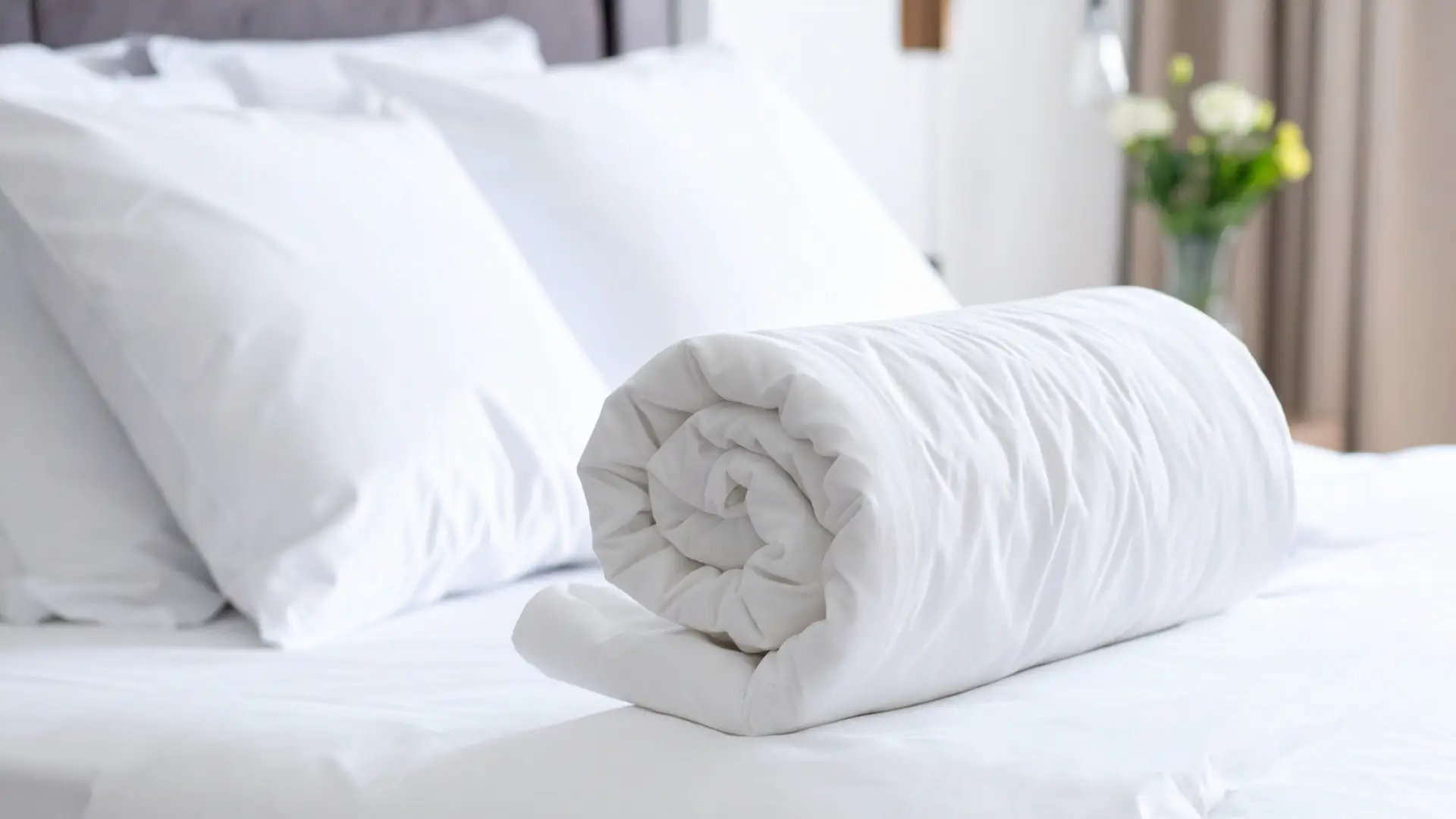 Rolled up duvet on a bed