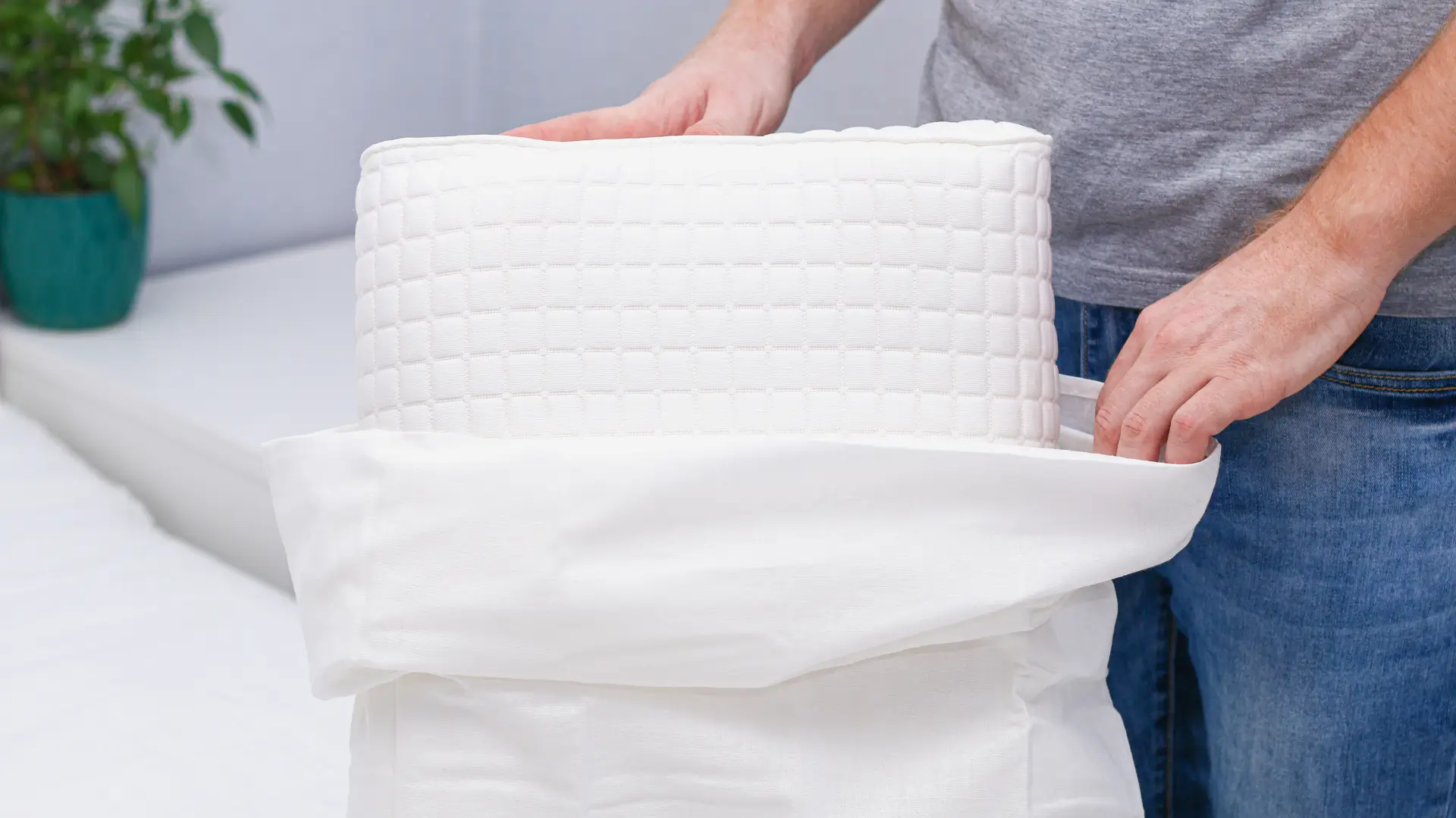 Man putting on pillowcase