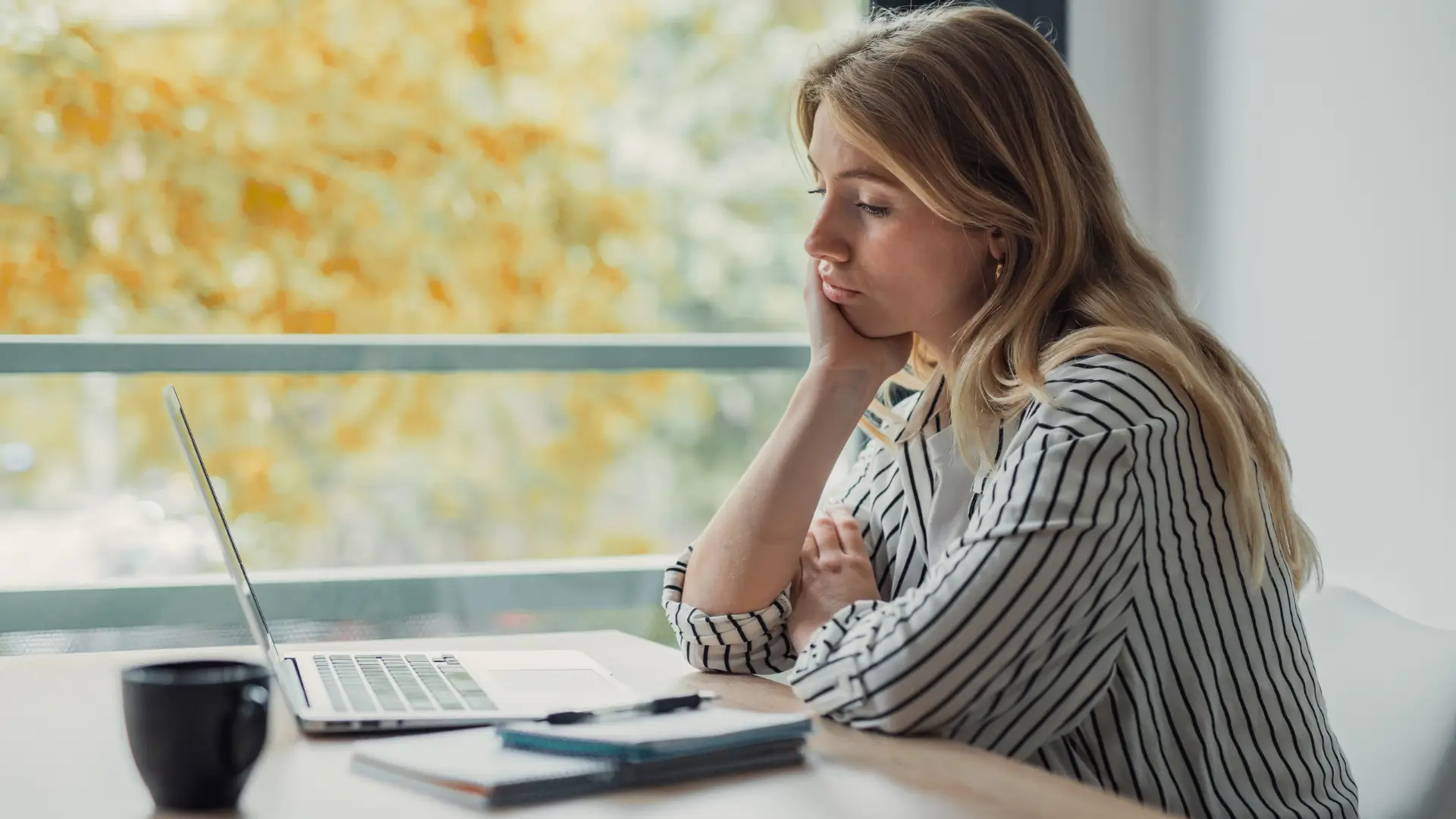 Woman tired at desk with coffee